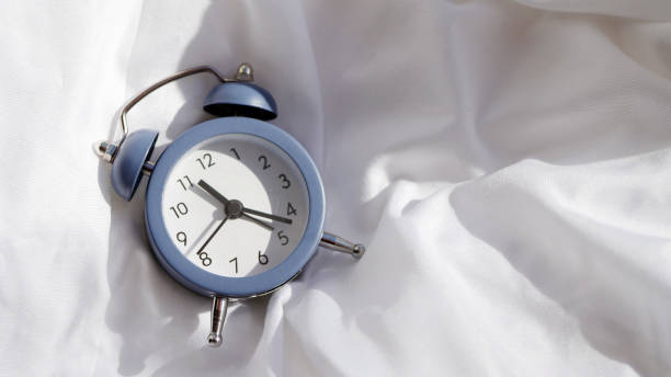 istock Alarm clock lay on the bed 1373541254
