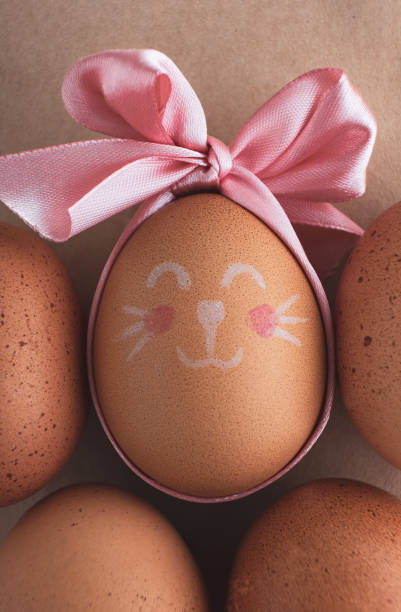istock Easter egg painted by hand and natural brown chicken eggs on kitchen table. 1373545687