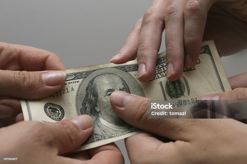 Give it to me!!!! Hands grabbing hundred dollars bill. US Paper Currency Stock Photo