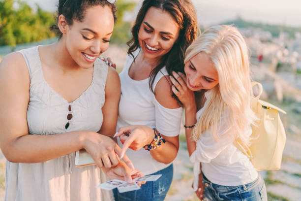istock Friends on vacation enjoying instant photos 1373574501
