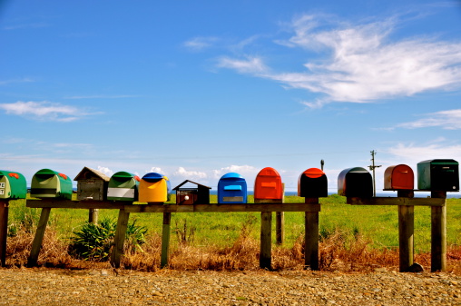 Mailboxes before green field and blue sky along the coast on the coromandel peninsula, NZ 2011
