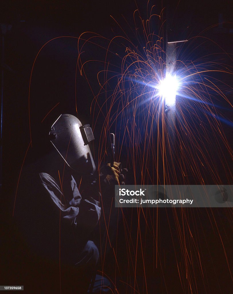 Welder Spark Welder with Flash sparkjng in the dark. Activity Stock Photo