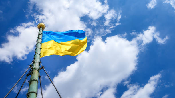 istock Ukrainian flag against blue dramatic sky 1373602760