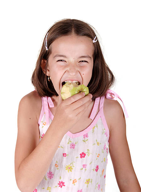 istock Young girl eats fresh green pear 137360386
