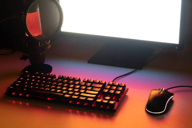istock gaming workspace for streamer. gaming set up with a gaming keyboard, a gaming mouse, a luminous microphone and a white screen 1373613819