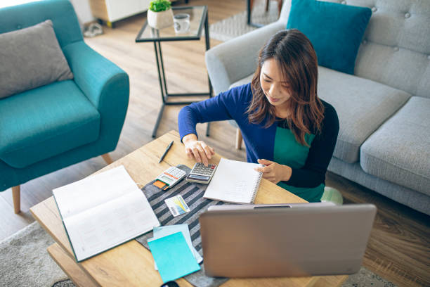 istock Young japanese woman doing her finances at home 1373623875