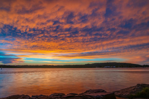 istock Sunrise by the bay with cumulonimbus clouds 1373639172