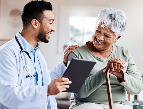 istock Shot of a young doctor sharing information from his digital tablet with an older patient 1373659740