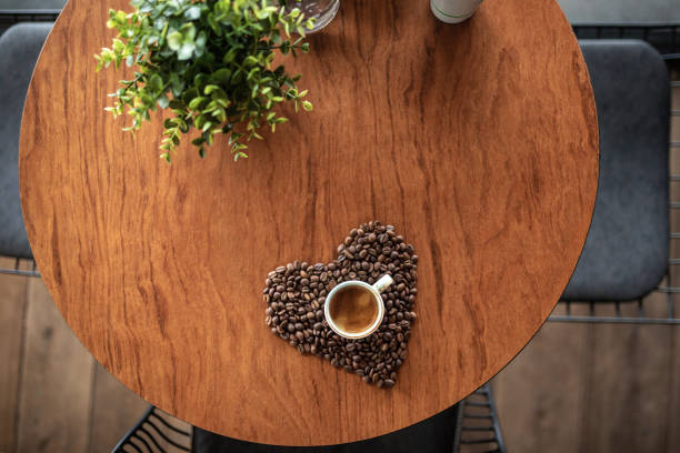 Cup of coffee inside of heart shape coffee beans