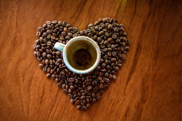 istock Empty cup of coffee inside of heart shape coffee beans 1373665443