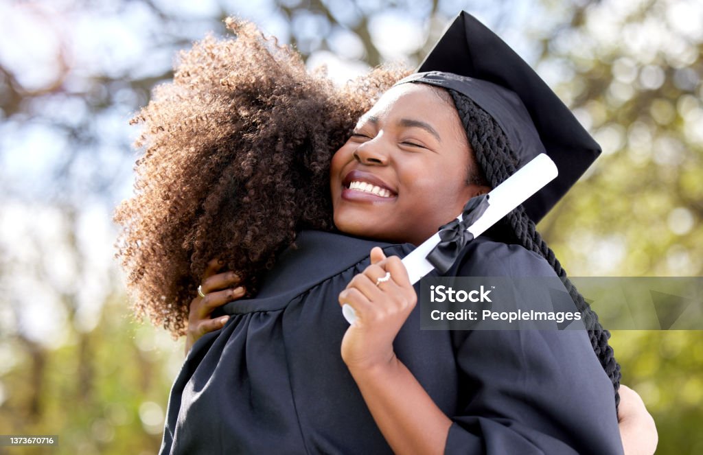 Shot of a young woman hugging her friend on graduation day I hope we never lose touch with each other Graduation Stock Photo