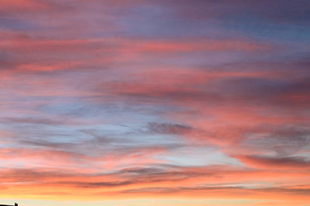 istock A beautiful dramatic sun set with reds, pinks, oranges, yellows interweaving the blue shaded sky backdrop perfect copy space 1373671754