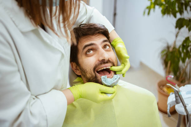 istock Man visiting a dental office 1373691802