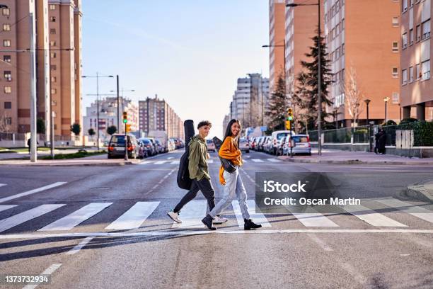 Hipster Teenage Urban Lifestyle Music Students Go To Class Or To A Concert Concept Of Pedestrian Crossing Traffic Laws And Lifestyle Stock Photo - Download Image Now