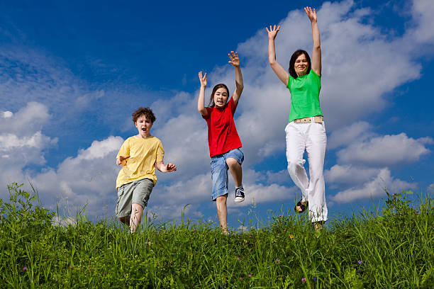 istock Mother with kids jumping outdoor 137373623