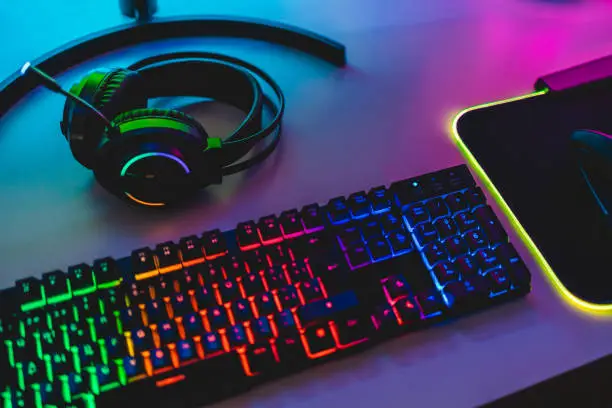 Photo of Gear equipment at gamer workspace - Rgb, keyboard, headphones and mouse