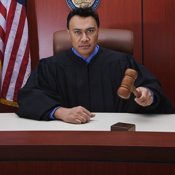 Male Judge With Gavel in Courtroom stock photo
