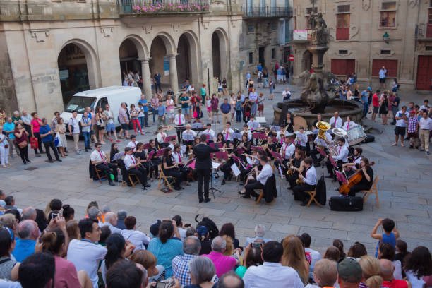 2018 June 22. Spain. Santiago de Compostela. Concert of classical music, on the square near the cathedral. Residents of the city, pilgrims and just tourists watching and enjoying the music.