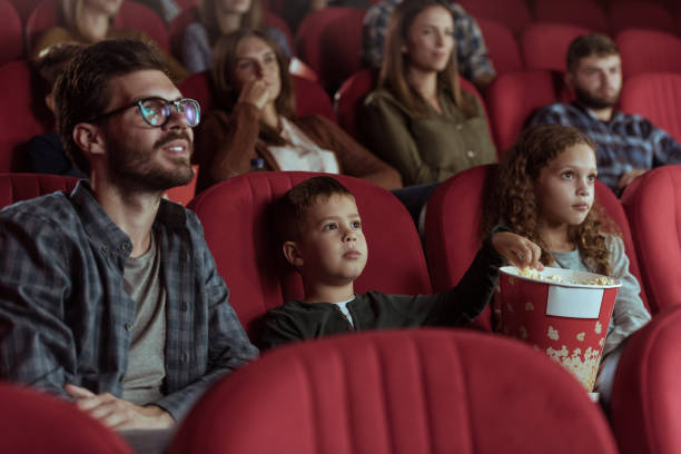 istock Single father with kids in cinema 1373791661