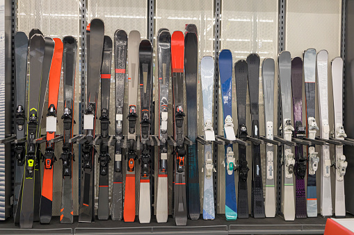 downhill skis on the shelves of a sports equipment store. photo