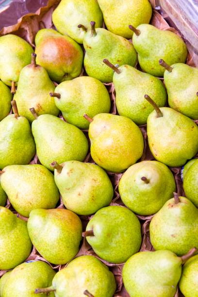 A crate full of fresh pears at a supermarket stock photo