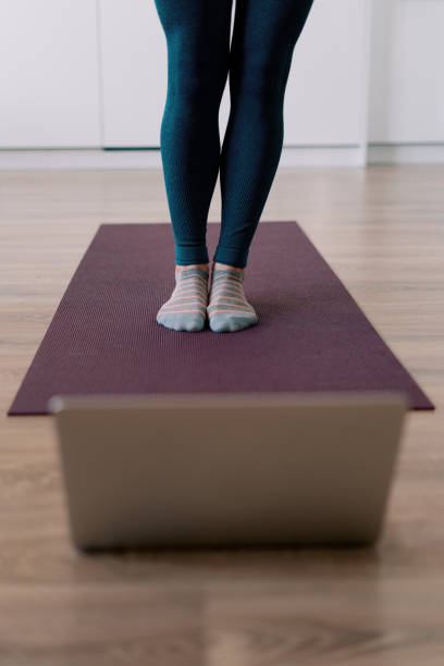 istock Woman legs practicing yoga at home 1373805104