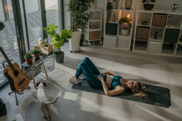 istock Woman exercising at home 1373829306
