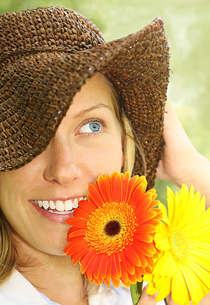 istock attractive girl with straw hat and daisies 137383060