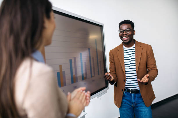 istock Young businessman showing some inside information on the monthly chart 1373835596