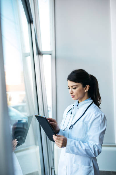 istock Young worried doctor looking at the results 1373843036