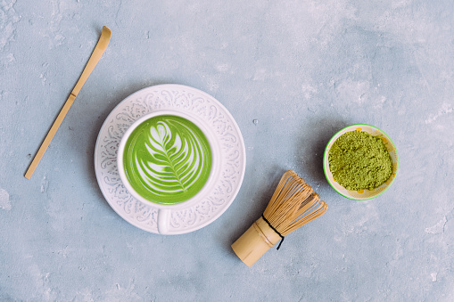 Green tea matcha drink, matcha latte on light background.  Healthy natural drink. Top view, copy space