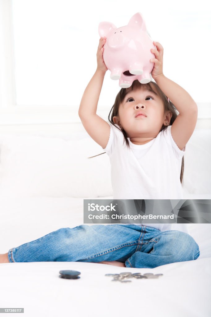 Girl empty piggy bank Girl empty piggy bank in bed Broken Stock Photo