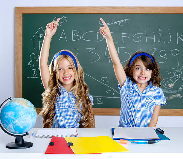 istock clever students in classroom raising hand 137385688