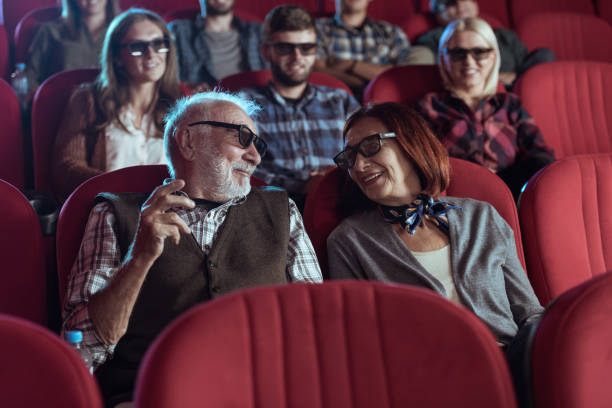 istock Senior couple watching 3D movie 1373877482