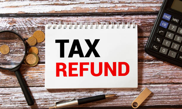 istock Notebook with a Business notes TAX REFUND on the office table with tools. Concept TAX REFUND 1373885228