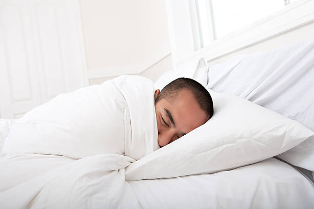 Man Sleeping On A Short Bed Stock Photos, Pictures & Royalty-Free Images - iStock