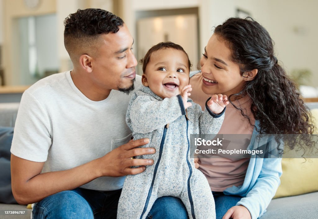 Shot of a young family bonding with their baby boy at home They cant resist this little one Family Stock Photo