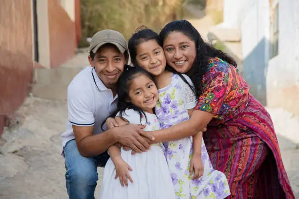 Photo of Portrait of a Latin family hugging in rural area - Happy Hispanic family in the village