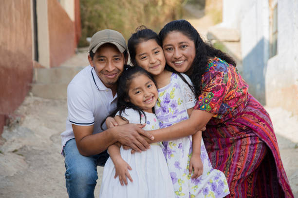 portrait of a latin family hugging in rural area - happy hispanic family in the village - etnicidade de índio imagens e fotografias de stock