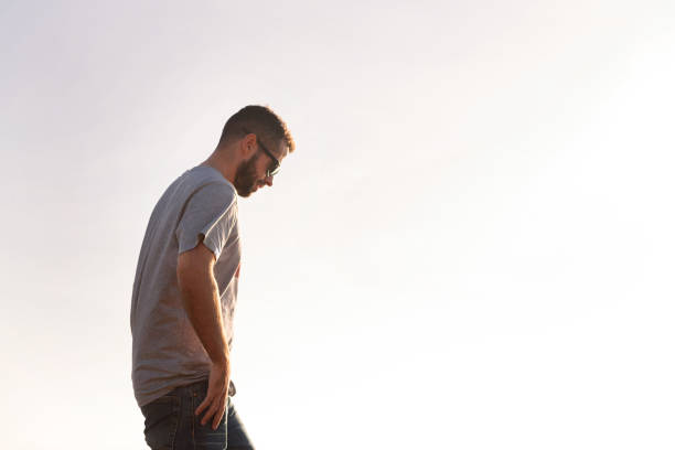 istock man with sunglasses walking with sky in background 1373929723