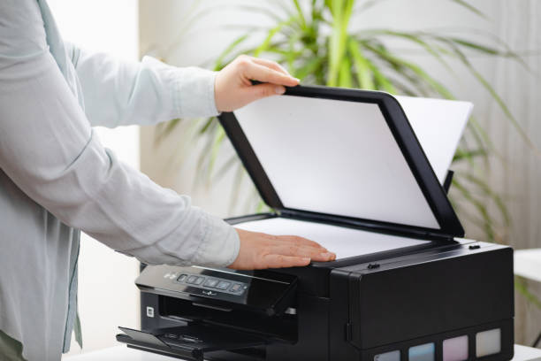 istock Secretary woman making a photocopy of important documents. Office manager using printer, scanner or laser copy machine. 1373937082