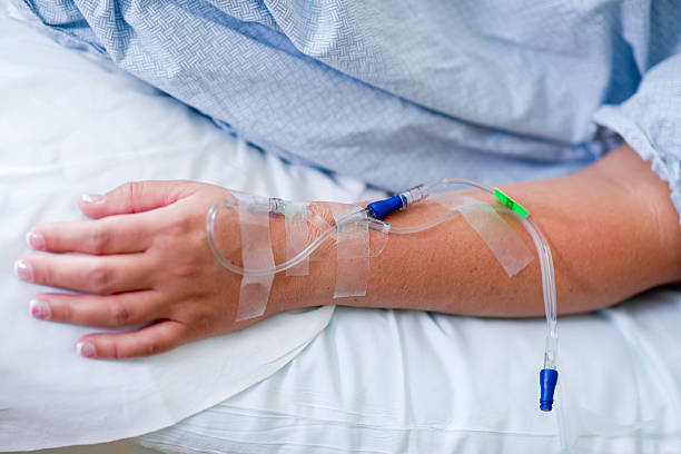 Close up of IV drip in patient's hand stock photo