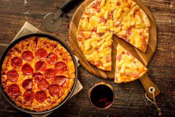 istock Hawaiian pizza and Pepperoni pizza on wood table 1373961611