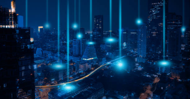 istock Smart city and wireless networking concept. Dot point connection technology with aerial view city background at night. 1374036012