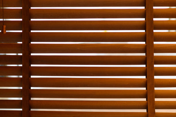 istock open wooden venetian blinds. lighting range control sunlight coming from a window. decoration interior. Modern jalousie. 1374039139