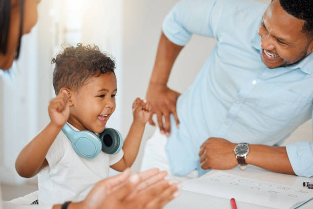 istock Shot of parents celebrating with their son while doing homework at home 1374062461