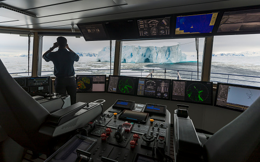 An officer on the bridge of a ship in Crystal Sound, Antarctica Peninsula on 10th January 2022. Antarctic ship based tourism is making a comeback after the Covid pandemic stopped travel there.
