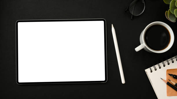 istock Dark modern workplace with portable touchpad 1374117037