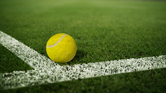 Close-up of tennis ball on white line painted on grass 3d render
