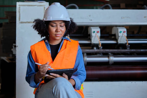 istock Female engineer worker quality control inspects by tablet at a paper factory. 1374167898